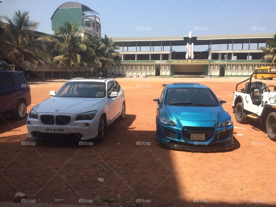 Stunning sports car and the bmw in our football play ground in india at kozhikode