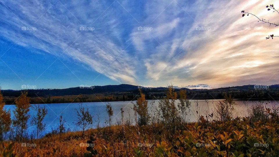 Sunset and smoke from a nearby forest fire create a eerie but beautiful scene over a lake in Canada.
