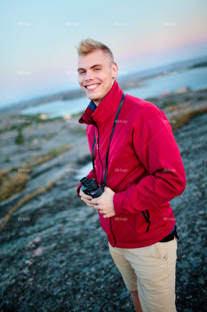 Happy man with binoculars