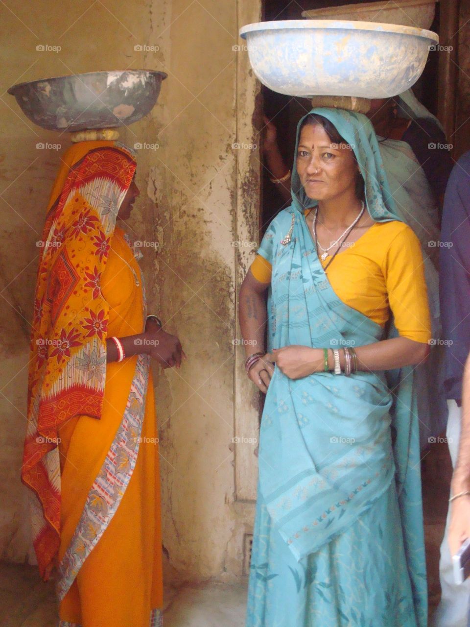 Two women carrying water