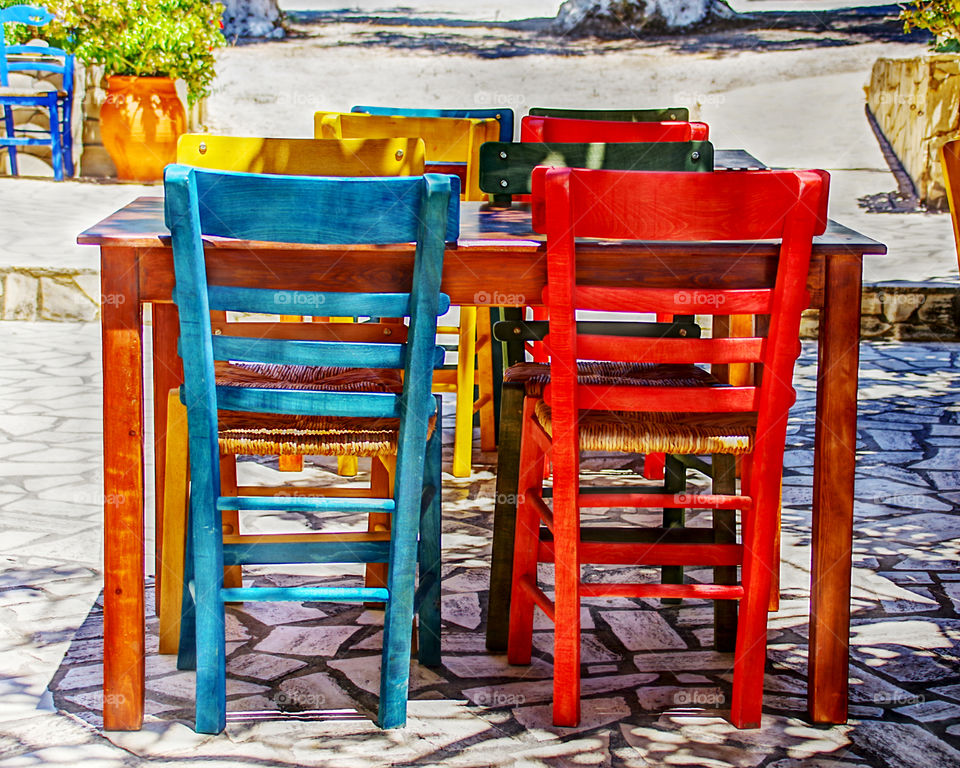 Table and chairs with intense and vivid colors of a Greek tavern