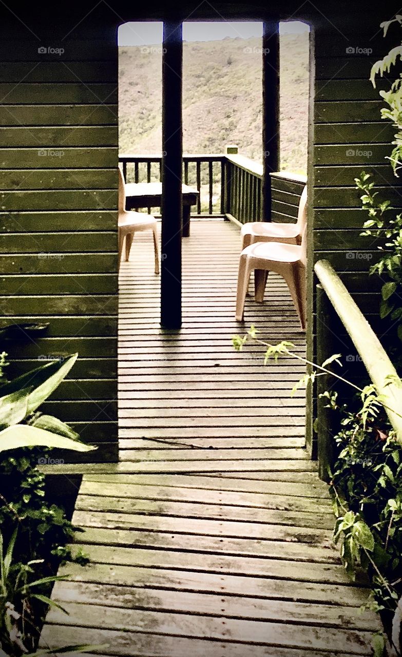 A path leading to a great outlook to the mountains, the wild, the trees and the bees. Wood deck