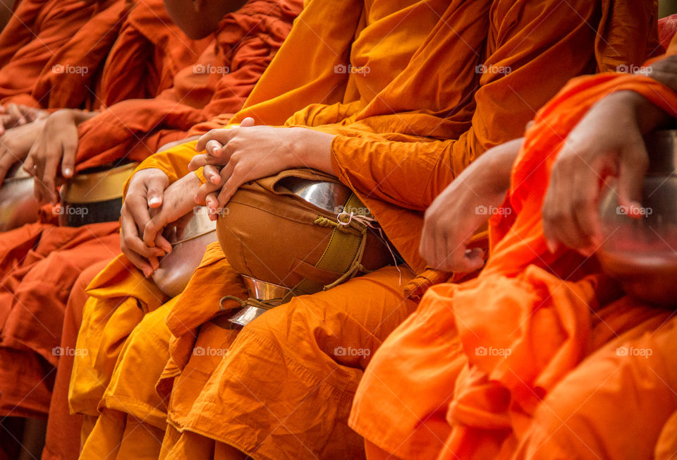 Monks in orange robe with begging bowls