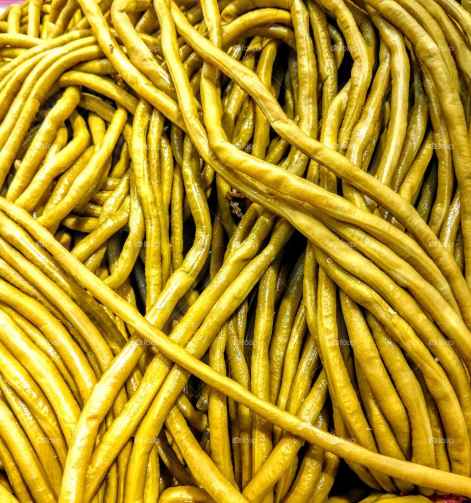 several bunches of pickled yard-long beans. looked color bright and beautiful.also everything becomes beautiful when amount is plenty.