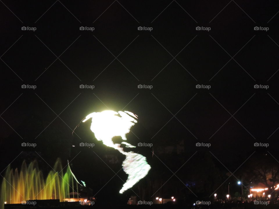 An illuminated version of Earth makes its way around the World Showcase lagoon during IllumiNations at EPCOT at the Walt Disney World Resort in Orlando, Florida.