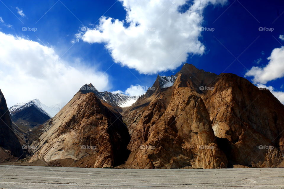 I see a big white puffy bird flying over the mountains. do you ?