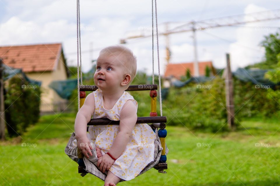 Baby girl on a swing