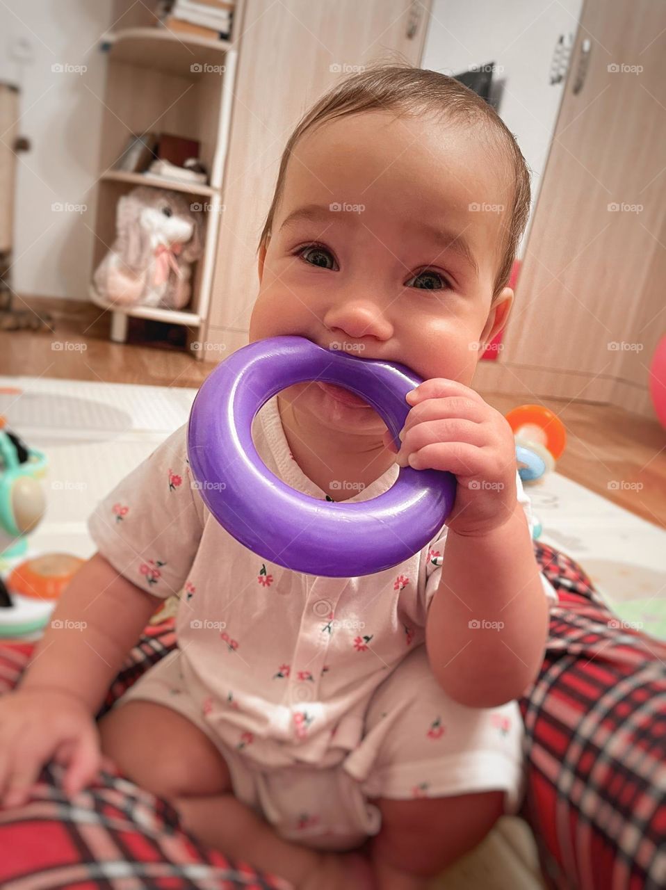 Baby girl with circle toy