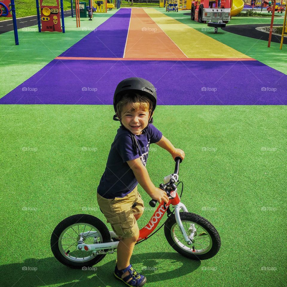Boy riding bike at Clemyjontri park in McLean VA