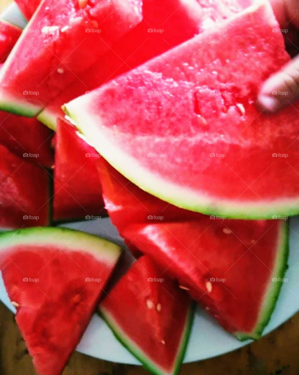 Juicy slices of watermelon on the plate to share