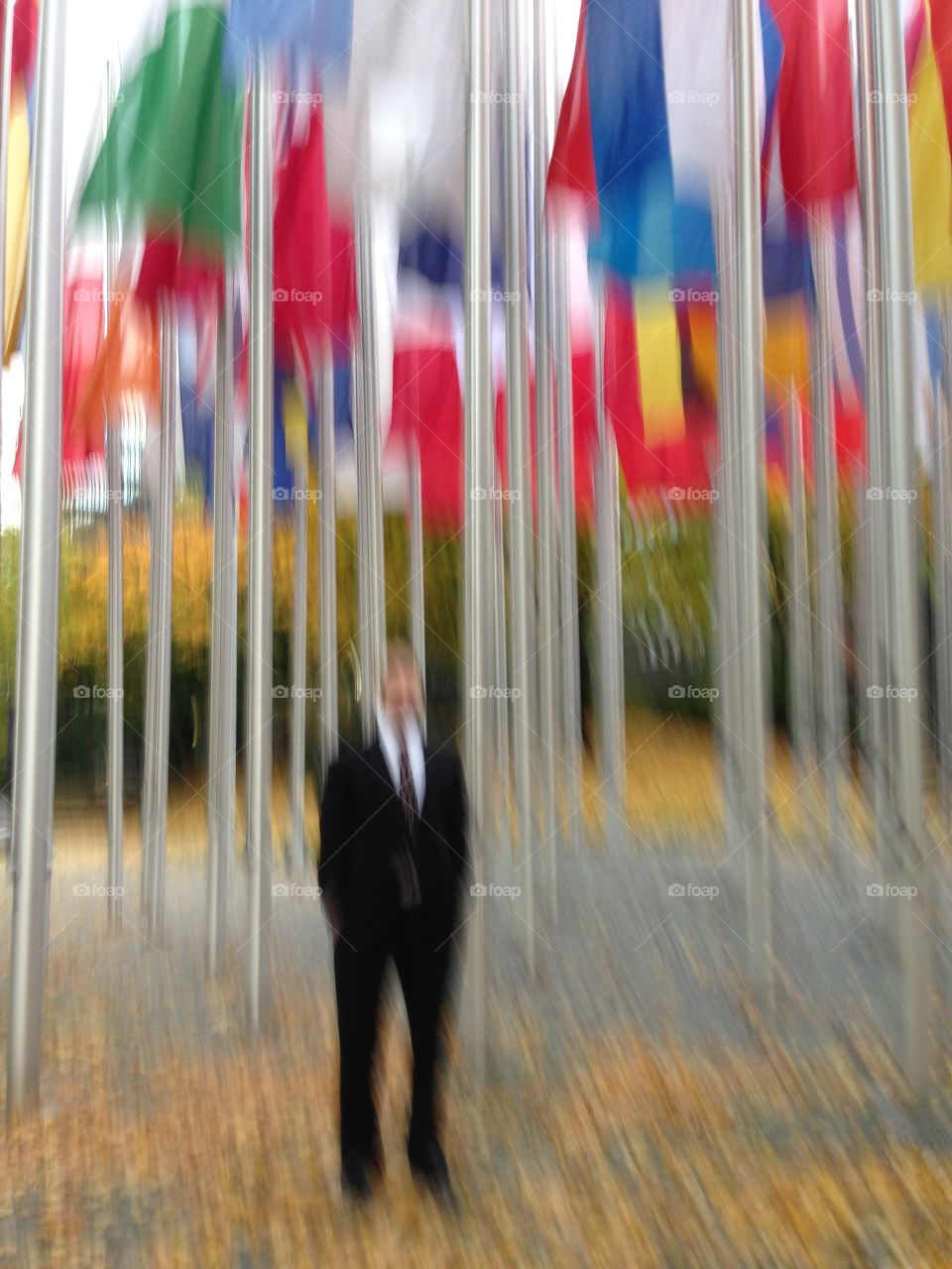 Man in front of flags