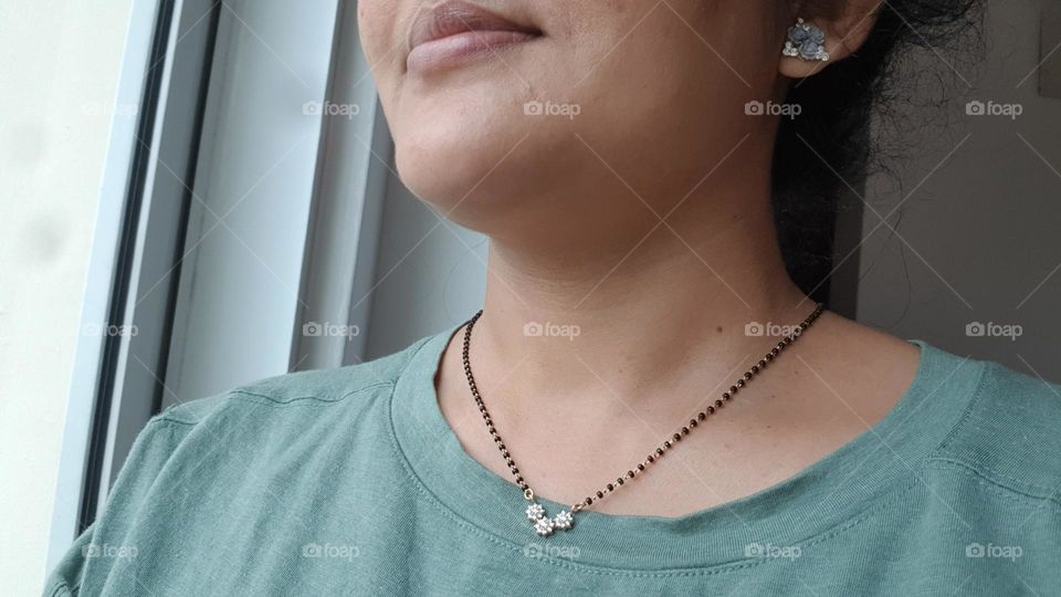 indian black beadsalong with dimond pendent and also blue ear ring