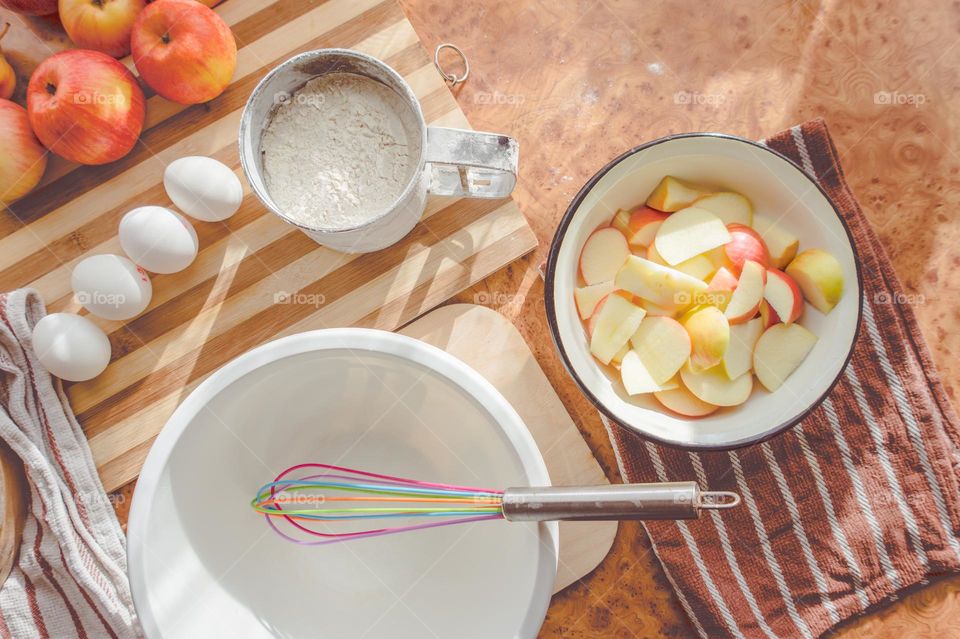 Making homemade puffed apple pie with eggs, sugar and flour.