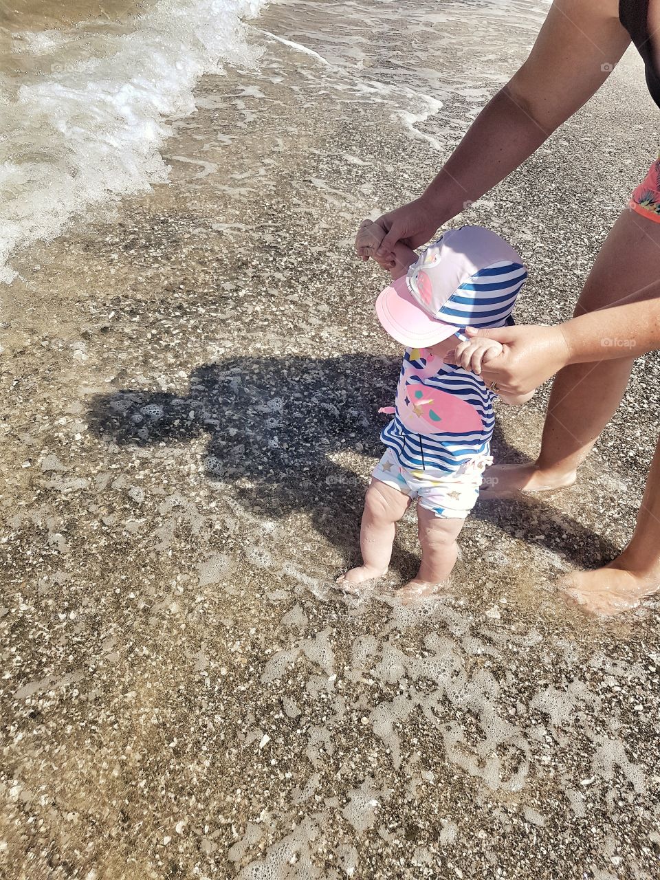 Baby Girl in Swimmers Paddling in Ocean Sand and Feet Summer Weather Beach