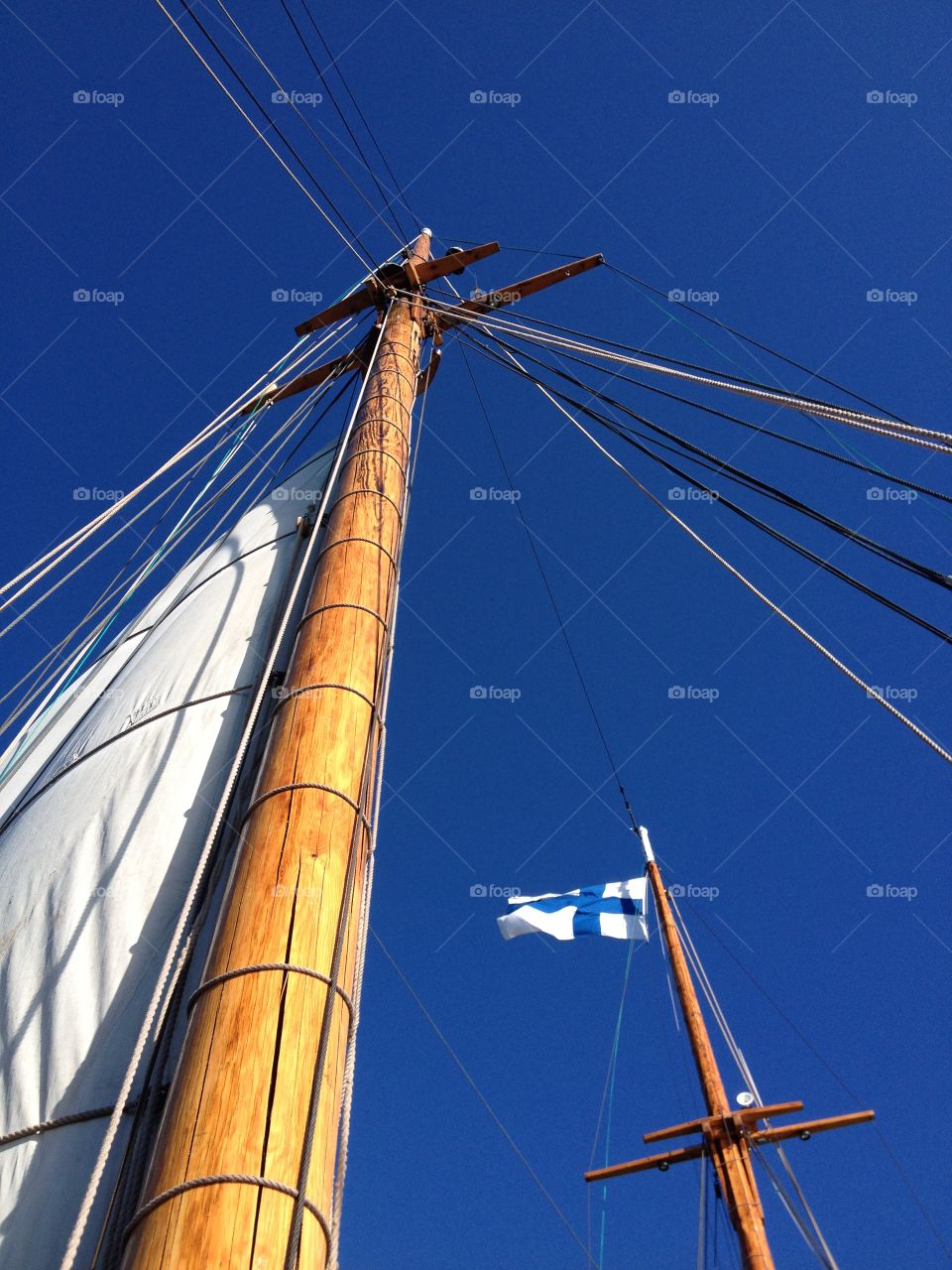 To catch the wind. Ship masts with Finnish flag