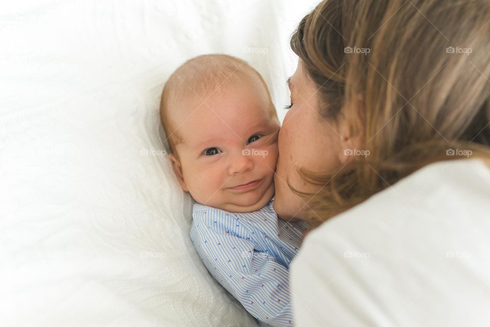 beautiful mother and six-month-old son, tender family photos, family spending time at home