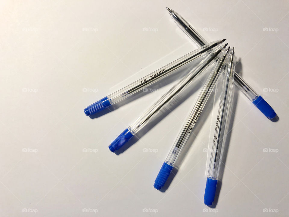 blue pens on white background
