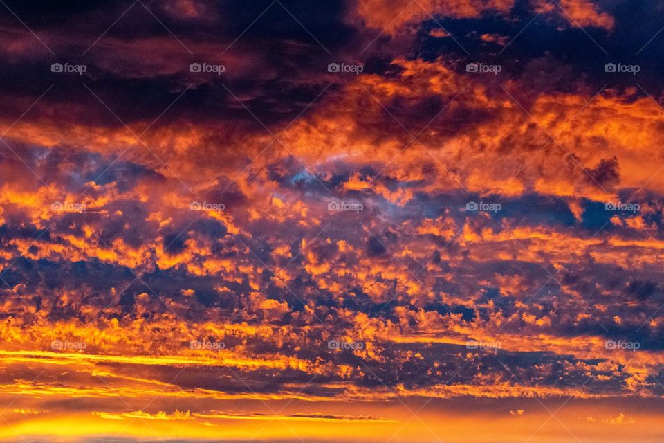 Sunset behind clouds displaying amazing colours