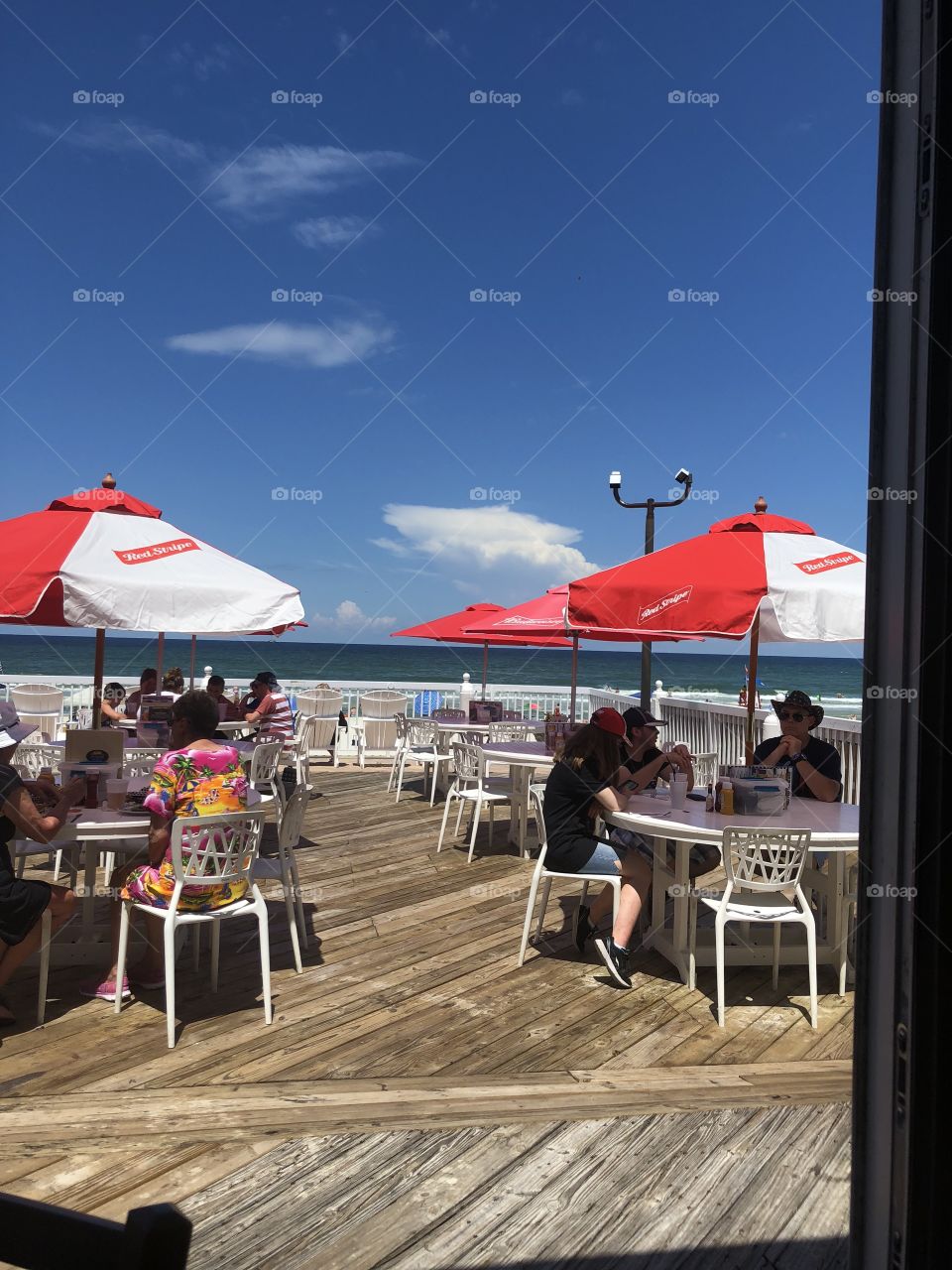A beautiful ocean view at a restaurant in Ponce Inlet, Florida. It was a gorgeous day right around Fourth of July, everyone was enjoying a wonderful meal while listening to the waves crash on the beach. 