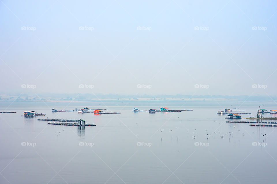 The raft floating fish farming and birds in Krasiew dam ,Supanburi Thailand.