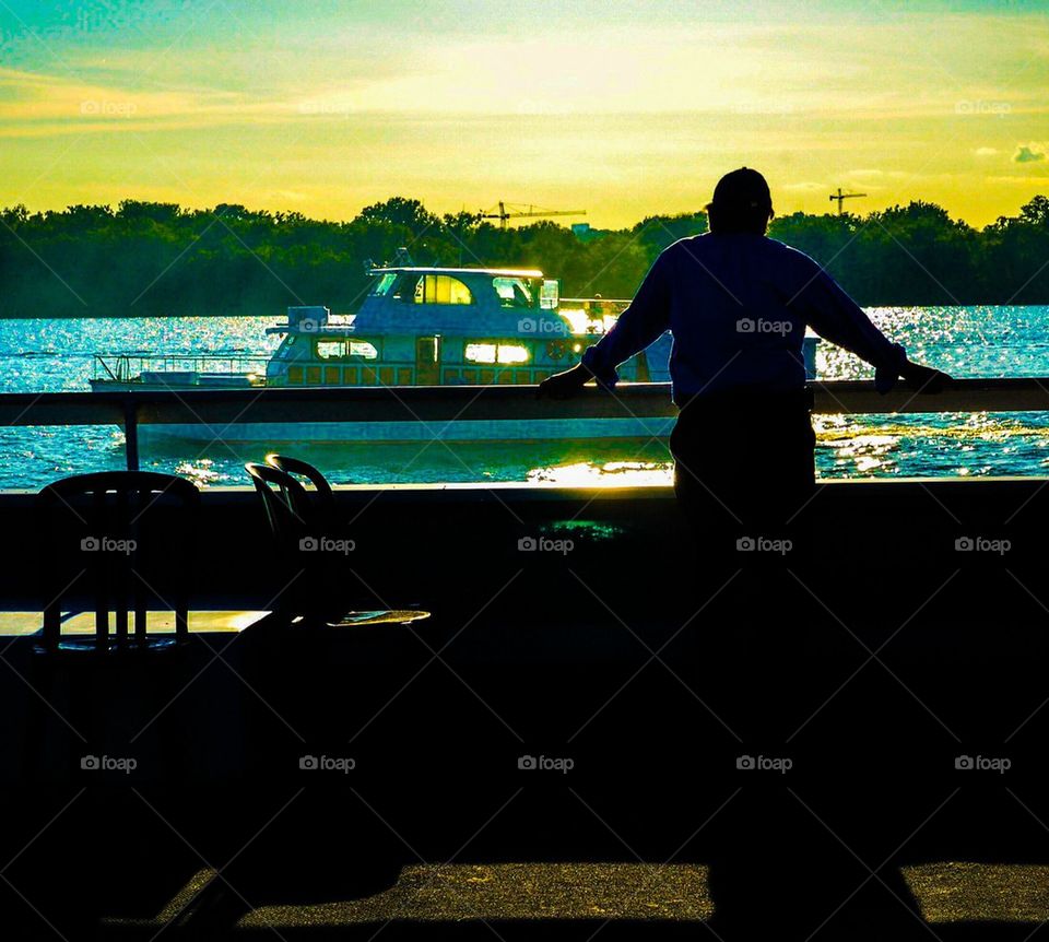 Silhouette of Man Watching Boat