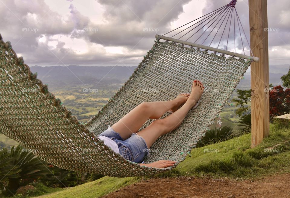 View of female legs on a hammock