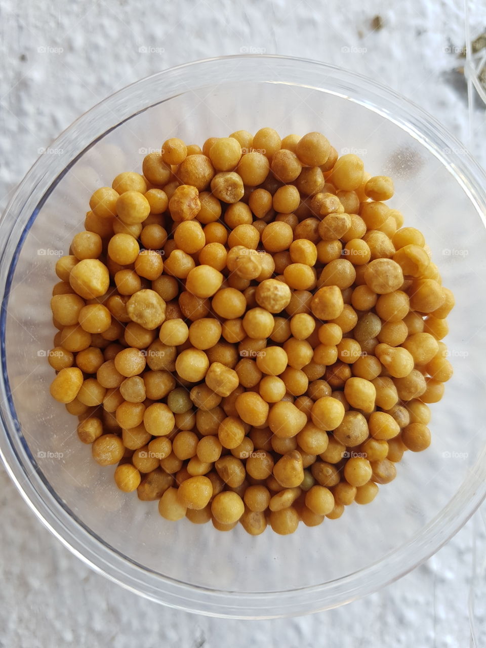 close up top view of a bowl full crispy yellow grain bowl