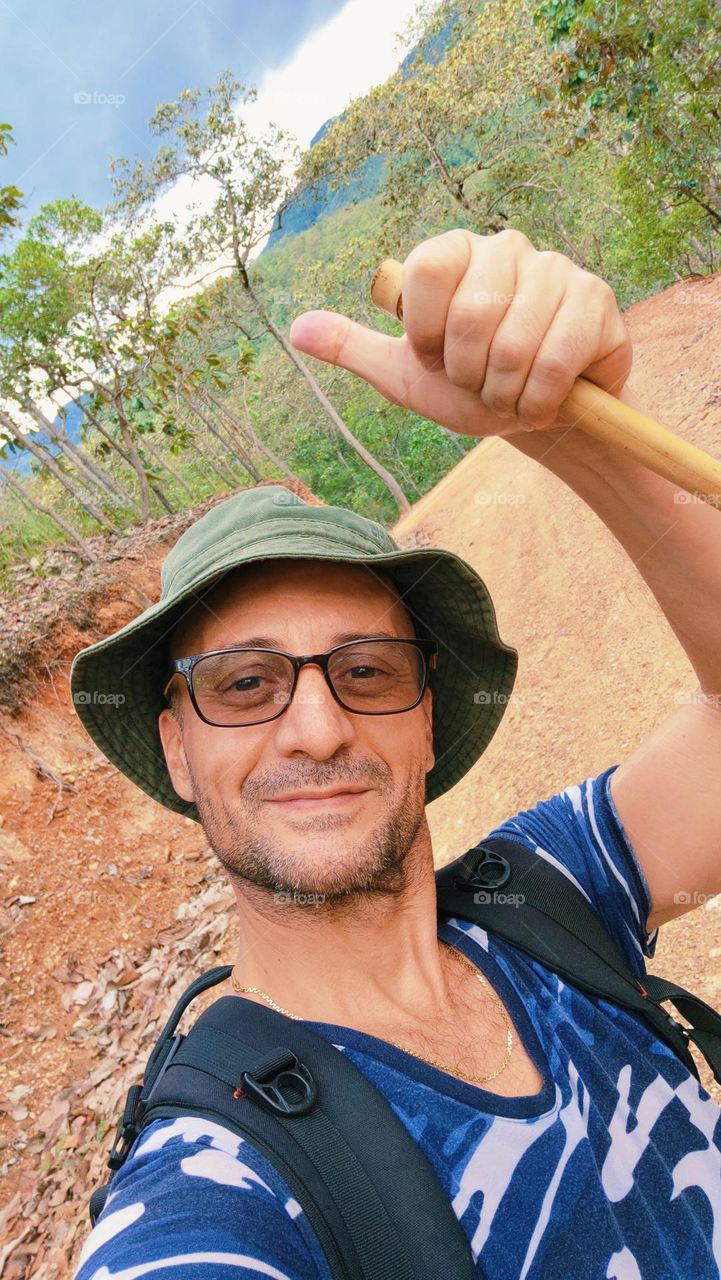 Happy man hiking in North Thailand forest