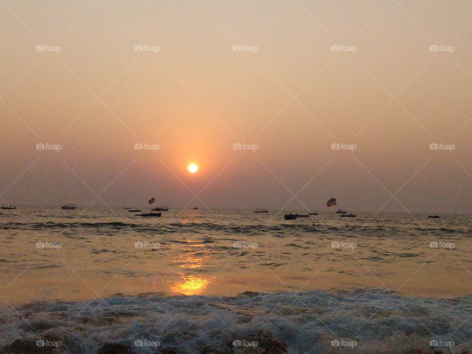 awesome sunset at the beach. sea shore photo with waves and beautiful dawn at the sea. waves, sea, sunset, dawn, boats, nature, beauty