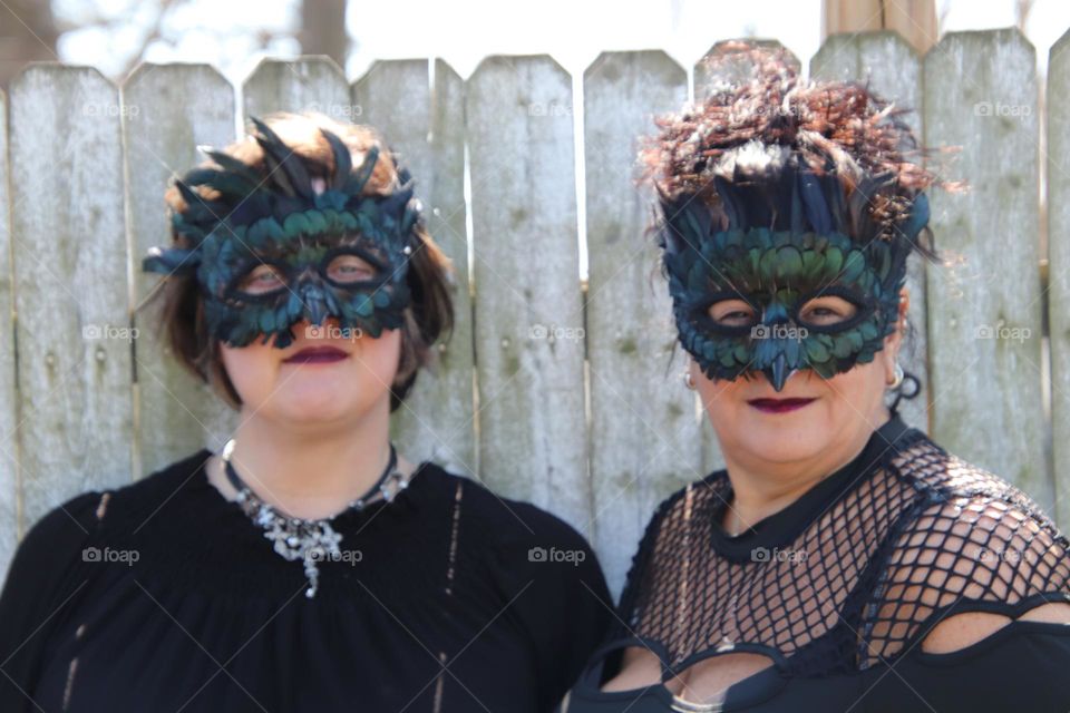 Woman wearing feather masquerade masks