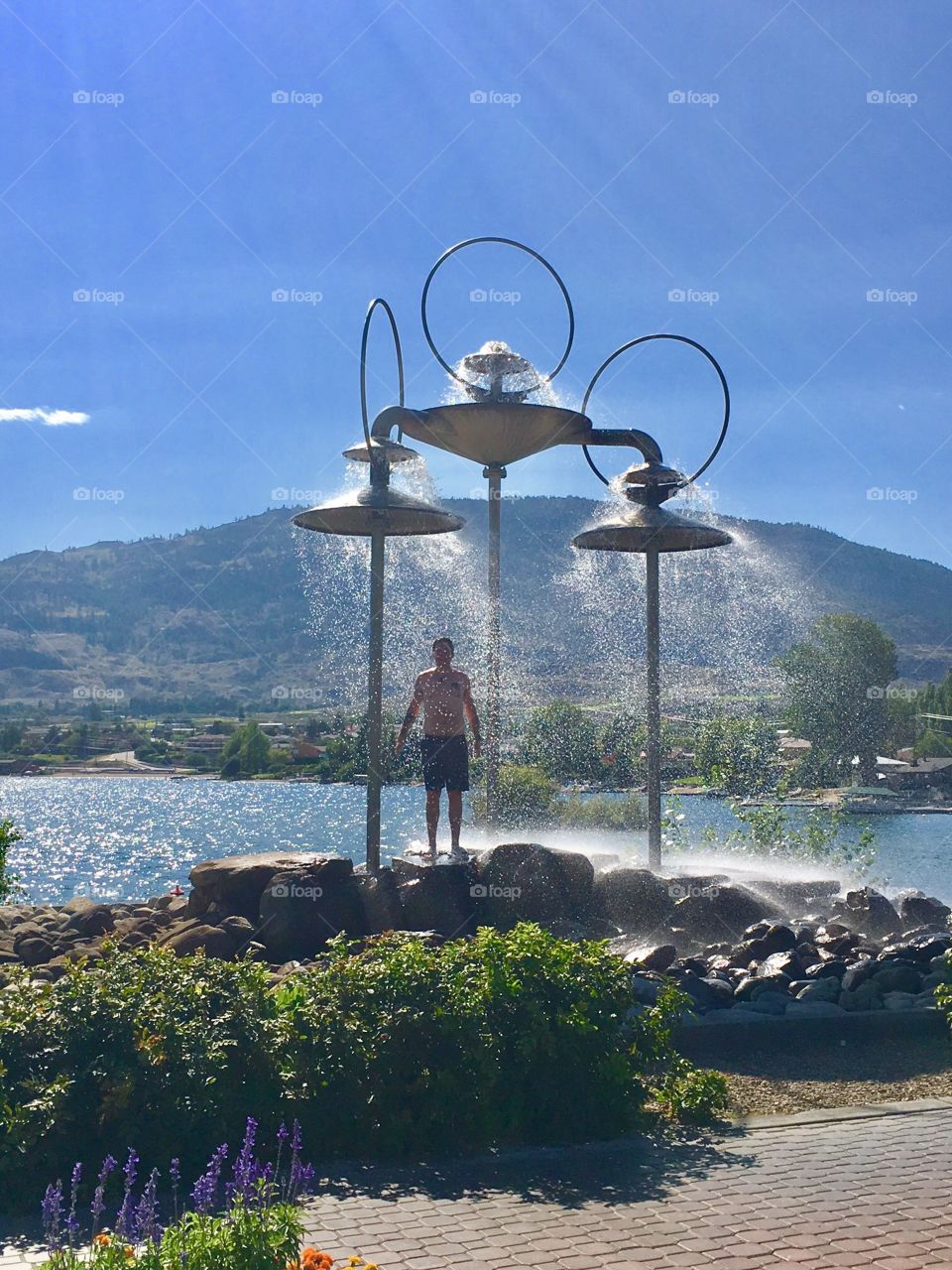 Cooling down in an outdoor water feature in Kelowna, British Columbia 