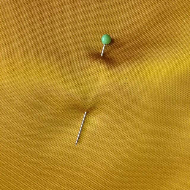 Pin in satin. Sewing pin in satin cloth
