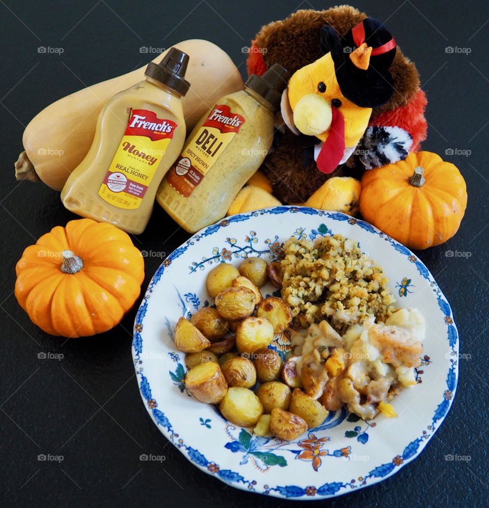 Thanksgiving plate of turkey in a creamy French’s deli and honey mustard sauce with stuffing and roasted potatoes.