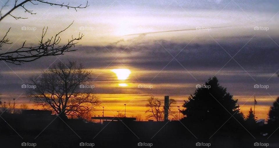 orange sunset behind fence in country