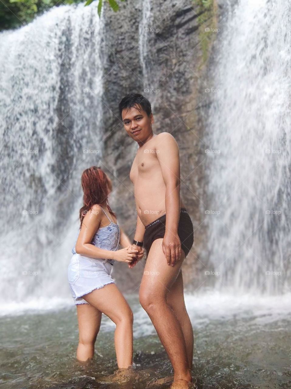 Portrait of a young couple on holiday at a waterfall