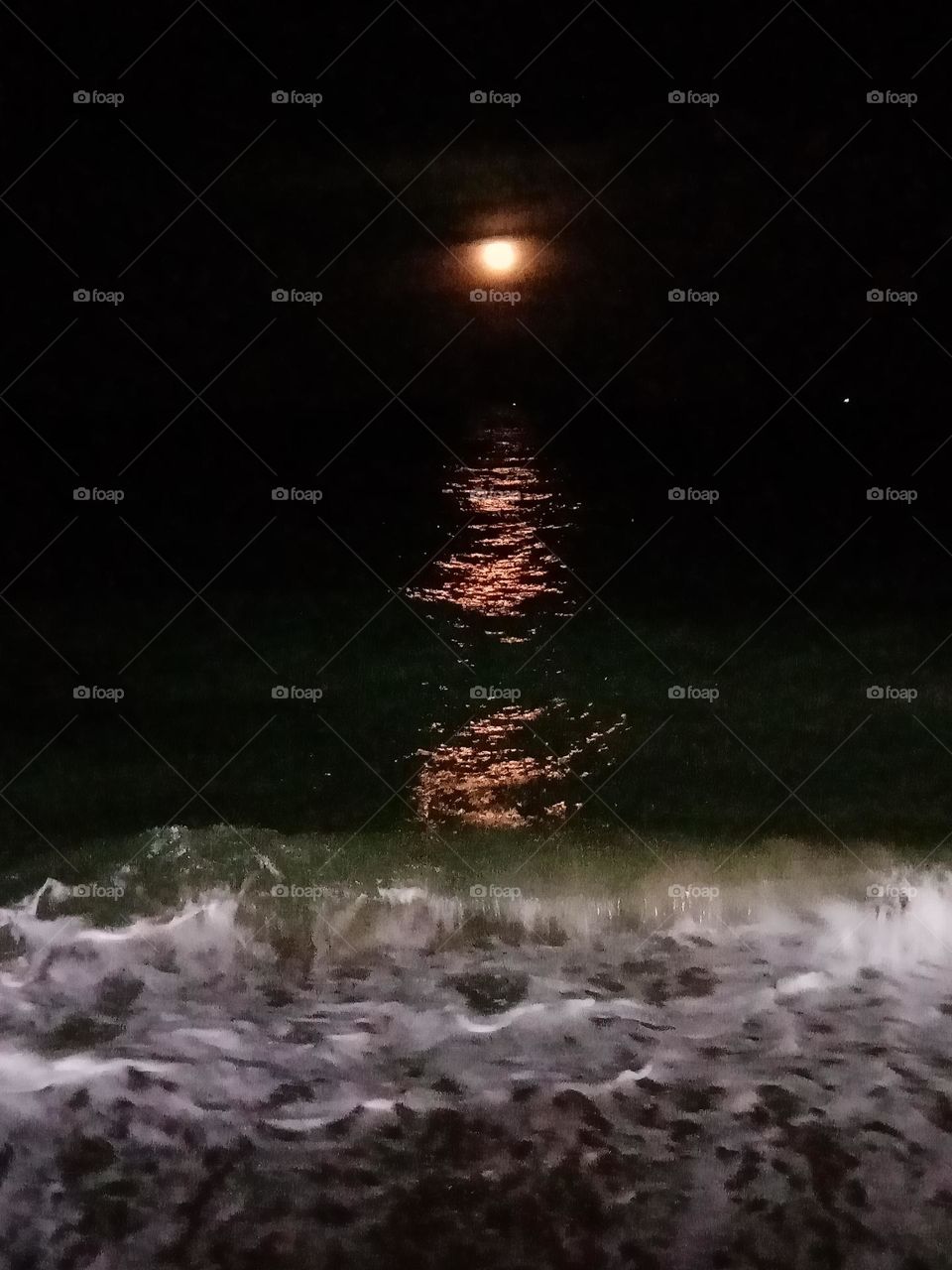 Moon's reflection on dark sea