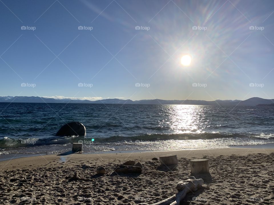 The sun shining bright reflecting on Tahoe lake. 