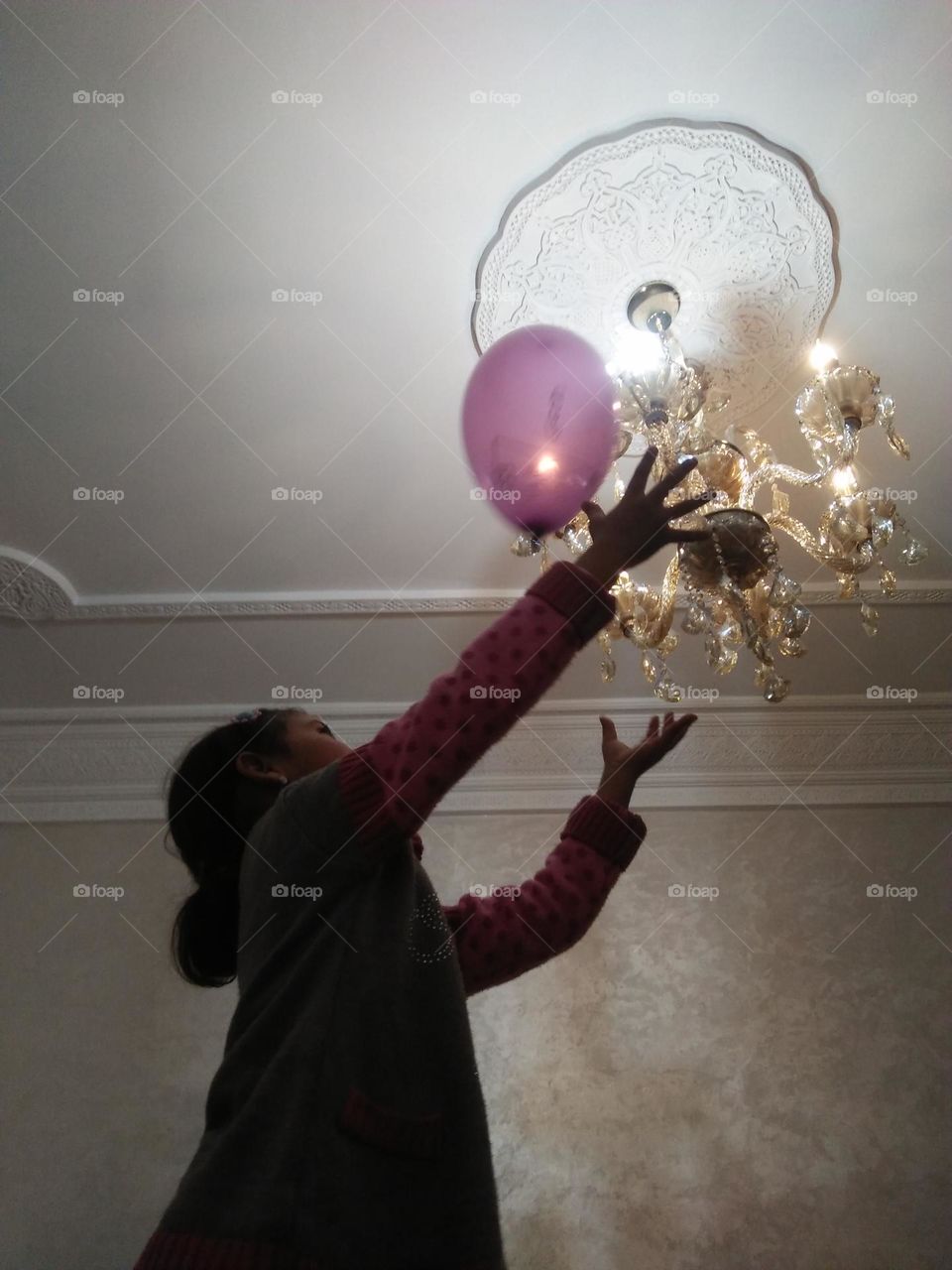 A young girl plays with Ballons