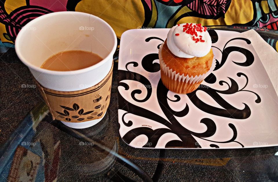 Coffee and cupcake. Almond flavored cupcakes with raspberry chill filling and delicious butter cream frosting