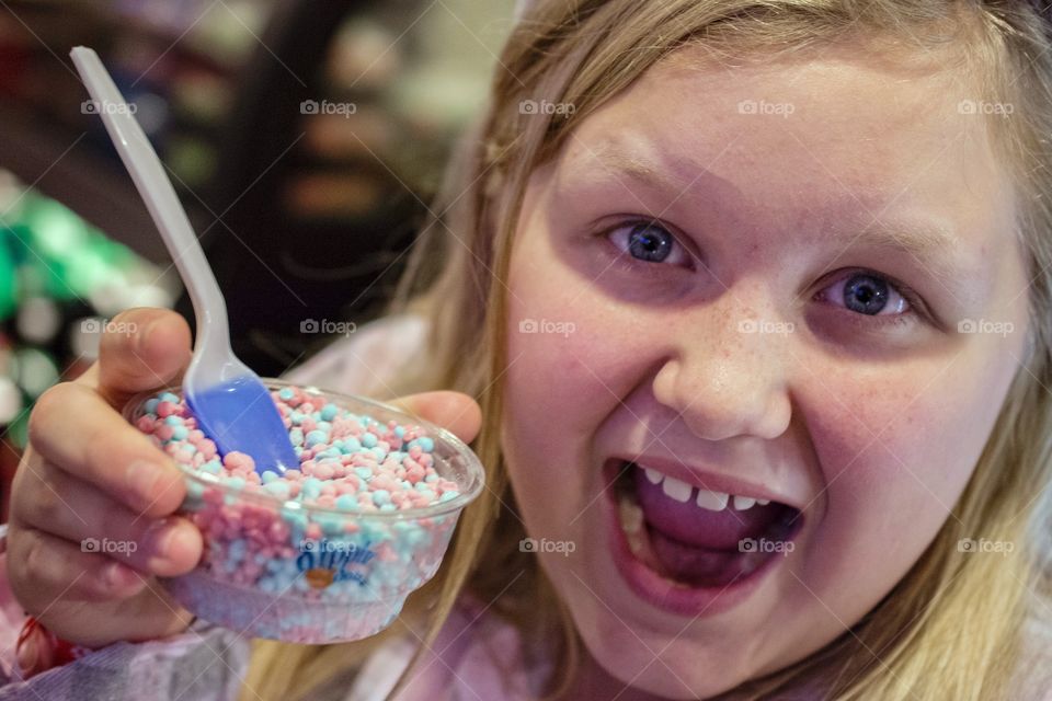 Young girl with cup of dippin dots