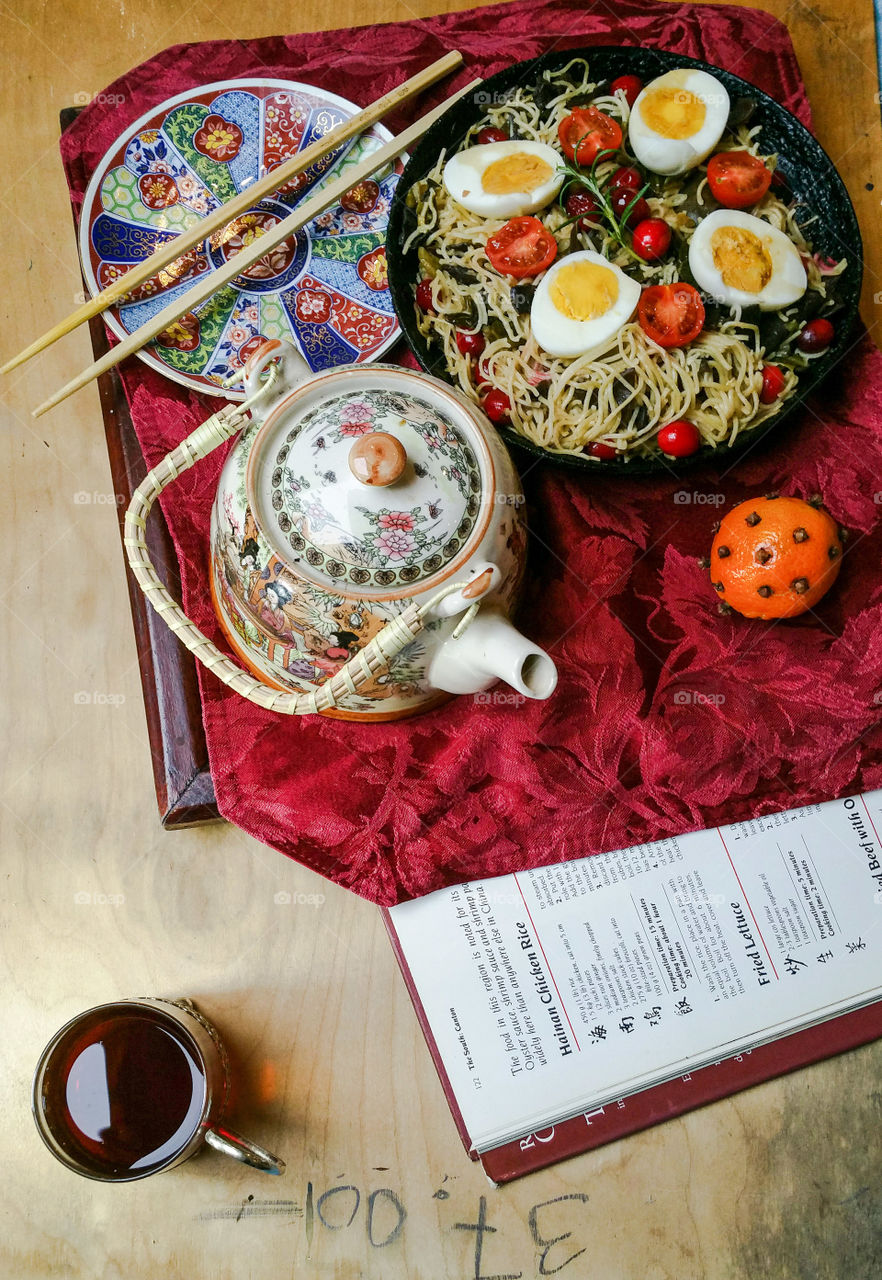 An oriental style lunch with tea and a teapot