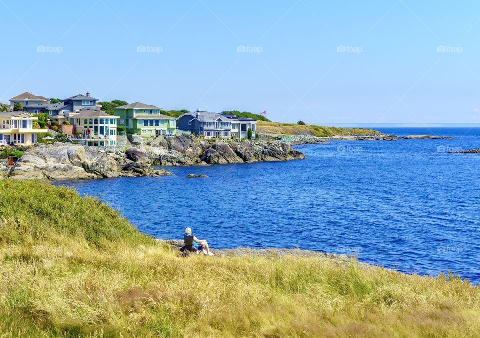 Line woman on vast ocean shore 