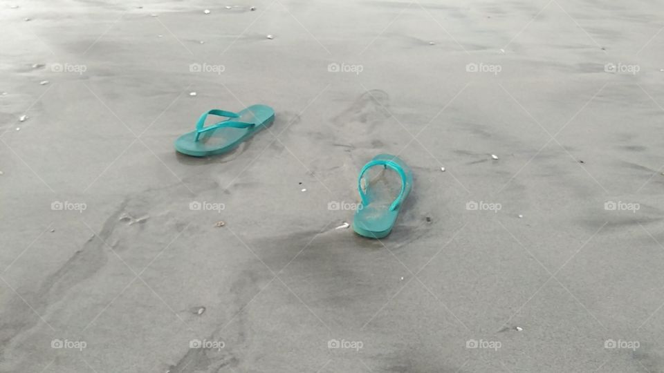 slippers lying on the beach