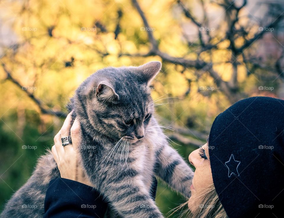 A woman and cat playing