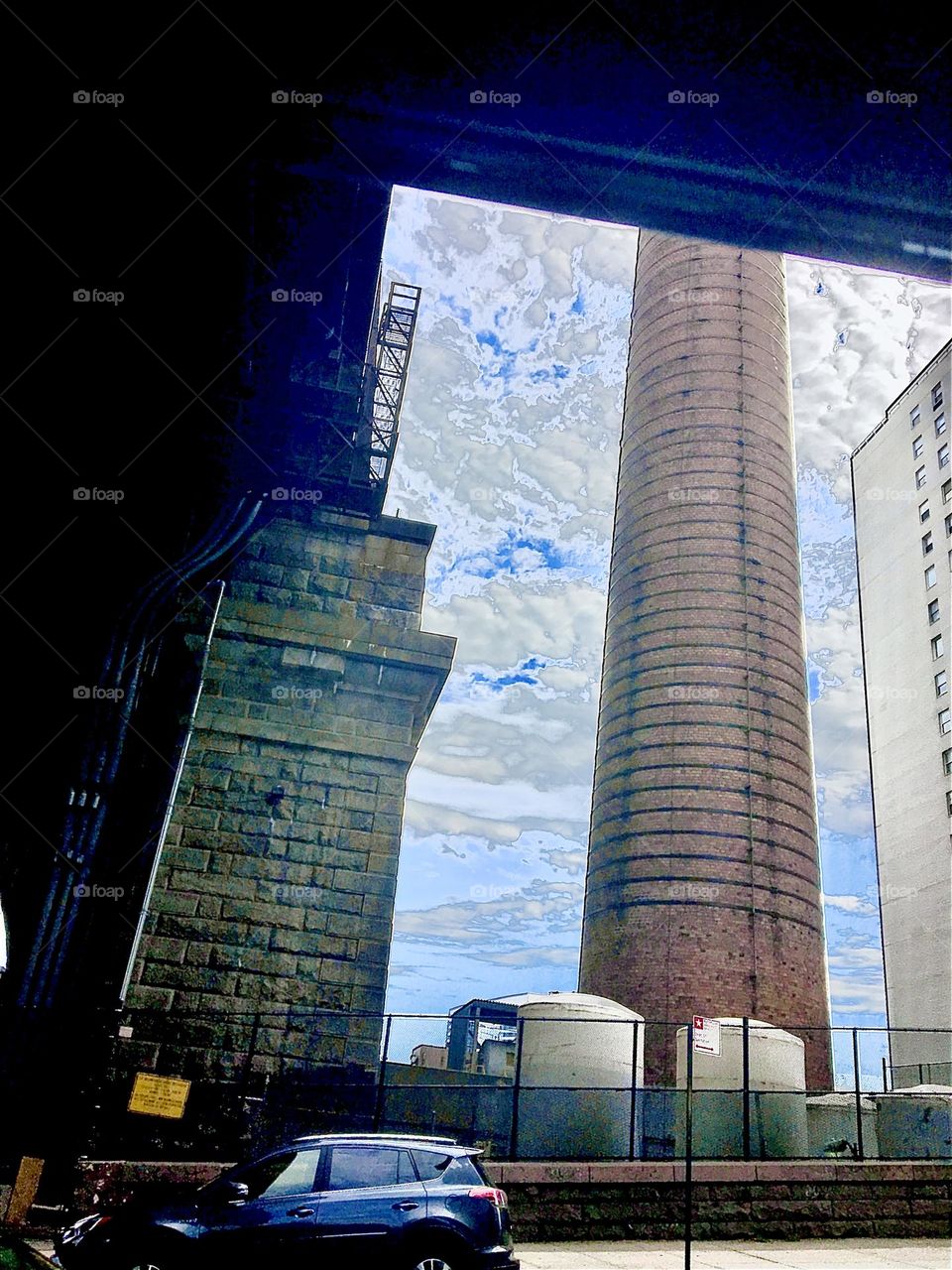 A highly unusual view of New York City while underway by car passing underneath the famous arch of the Manhattan bridge. A perfectly realistic theme can take on a surreal look simply because of the angle of perspective. 2021. Hypnotic Productions