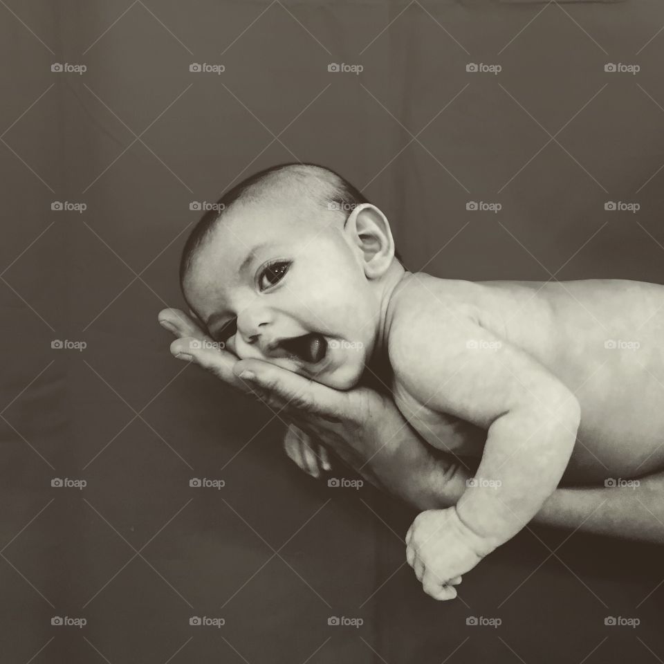 Close-up of a baby lying on person's hand