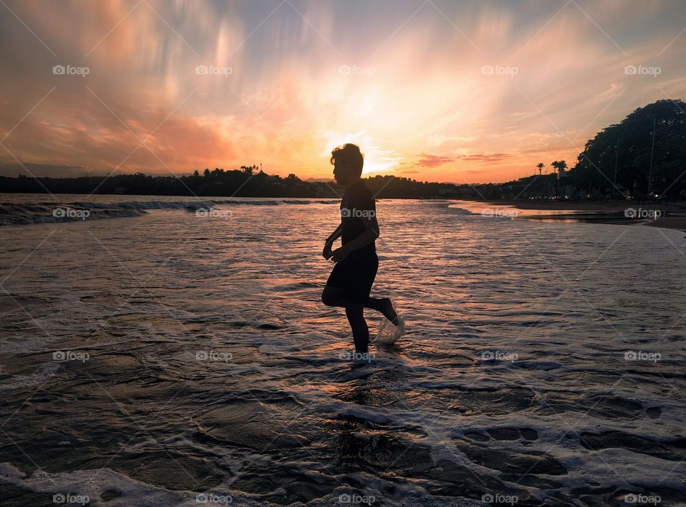 Bathing in the sea at dusk.