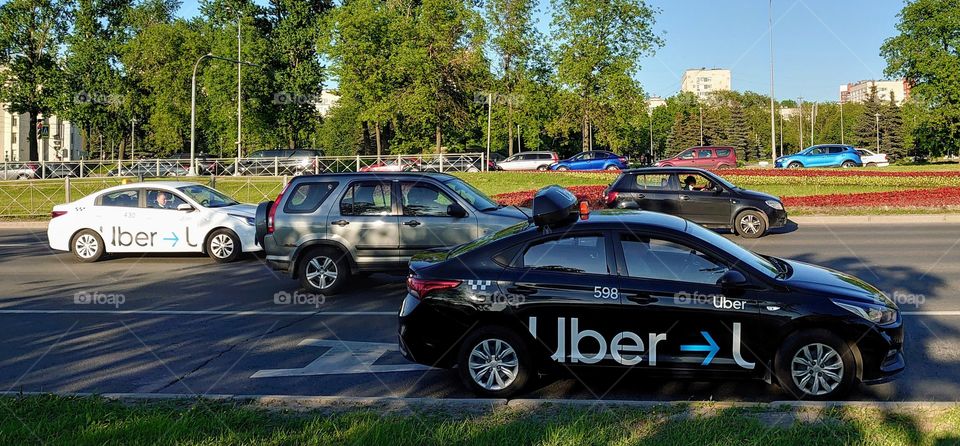 Two UBER cars on Pulkovskoe highway in St. Petersburg, Russia