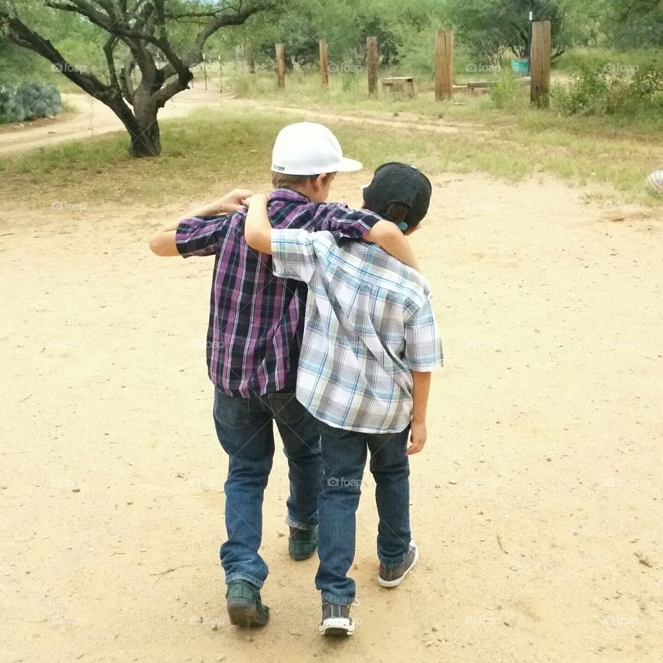 Brotherly advice. Two boys taking a walk together.