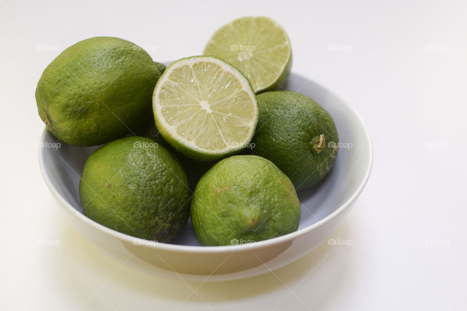 Studio shot of limes on bowl